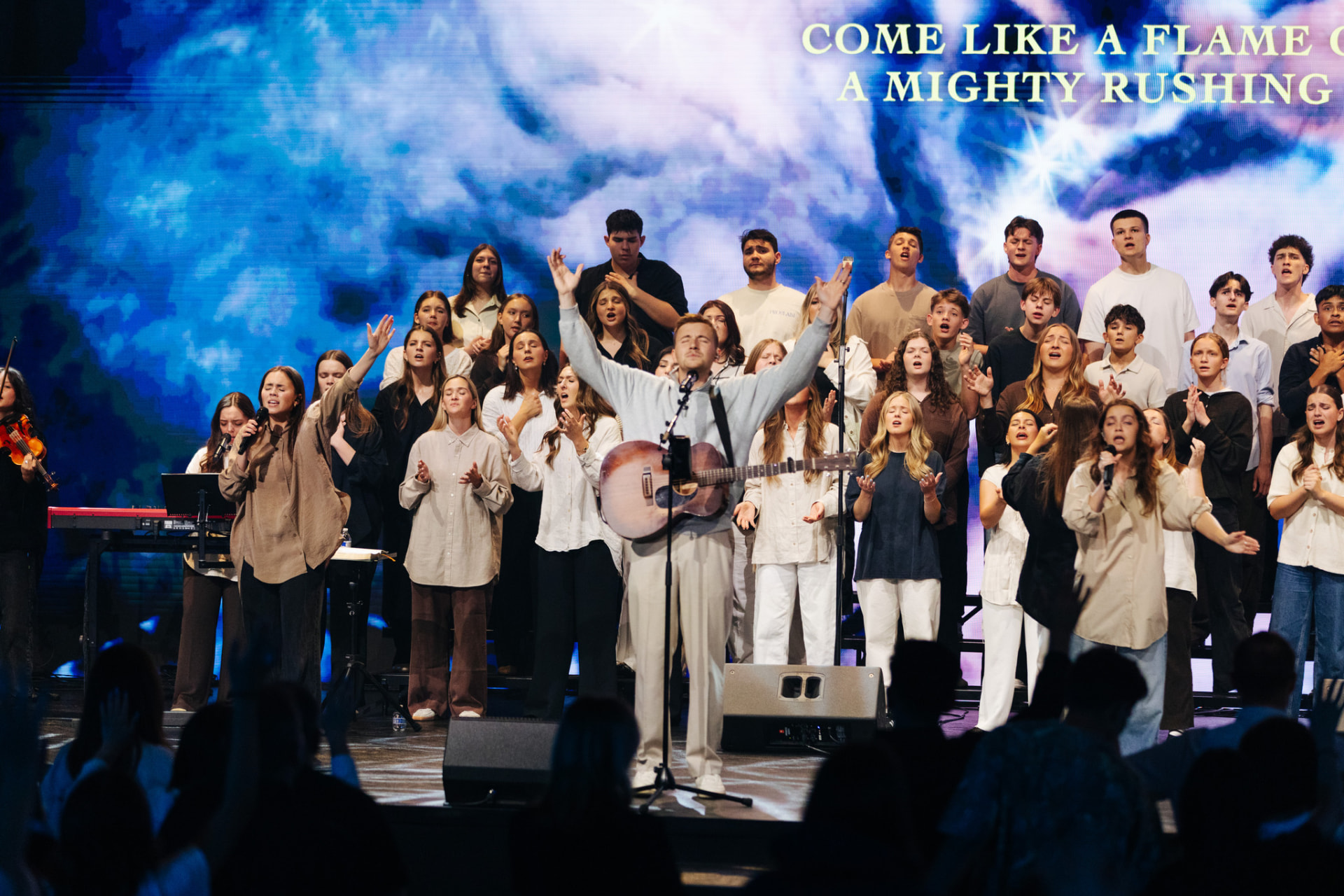 Congregation with raised hands during worship