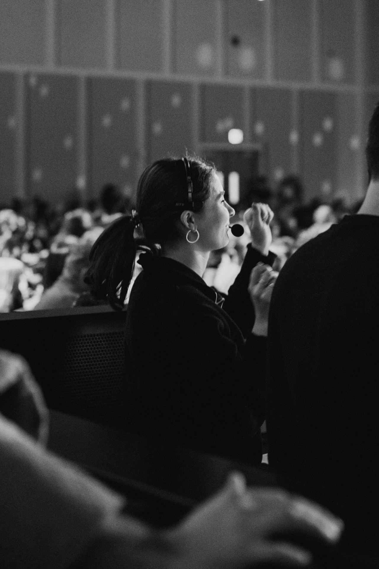 Volunteer stage manager calling cues on a headset during Night in Bethlehem